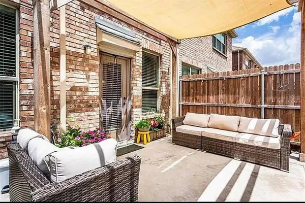 a balcony with furniture and a potted plant