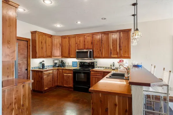 a kitchen with a stove a sink and a refrigerator