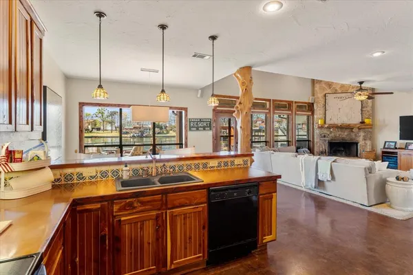 a kitchen with stainless steel appliances granite countertop a sink and wooden cabinets