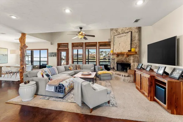 a living room with fireplace furniture and a flat screen tv