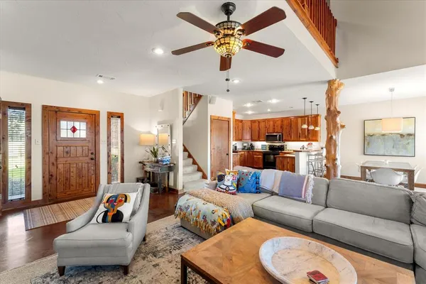 a living room with furniture and a chandelier