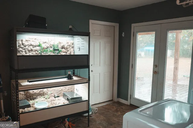 a living room with large window and a flat screen tv