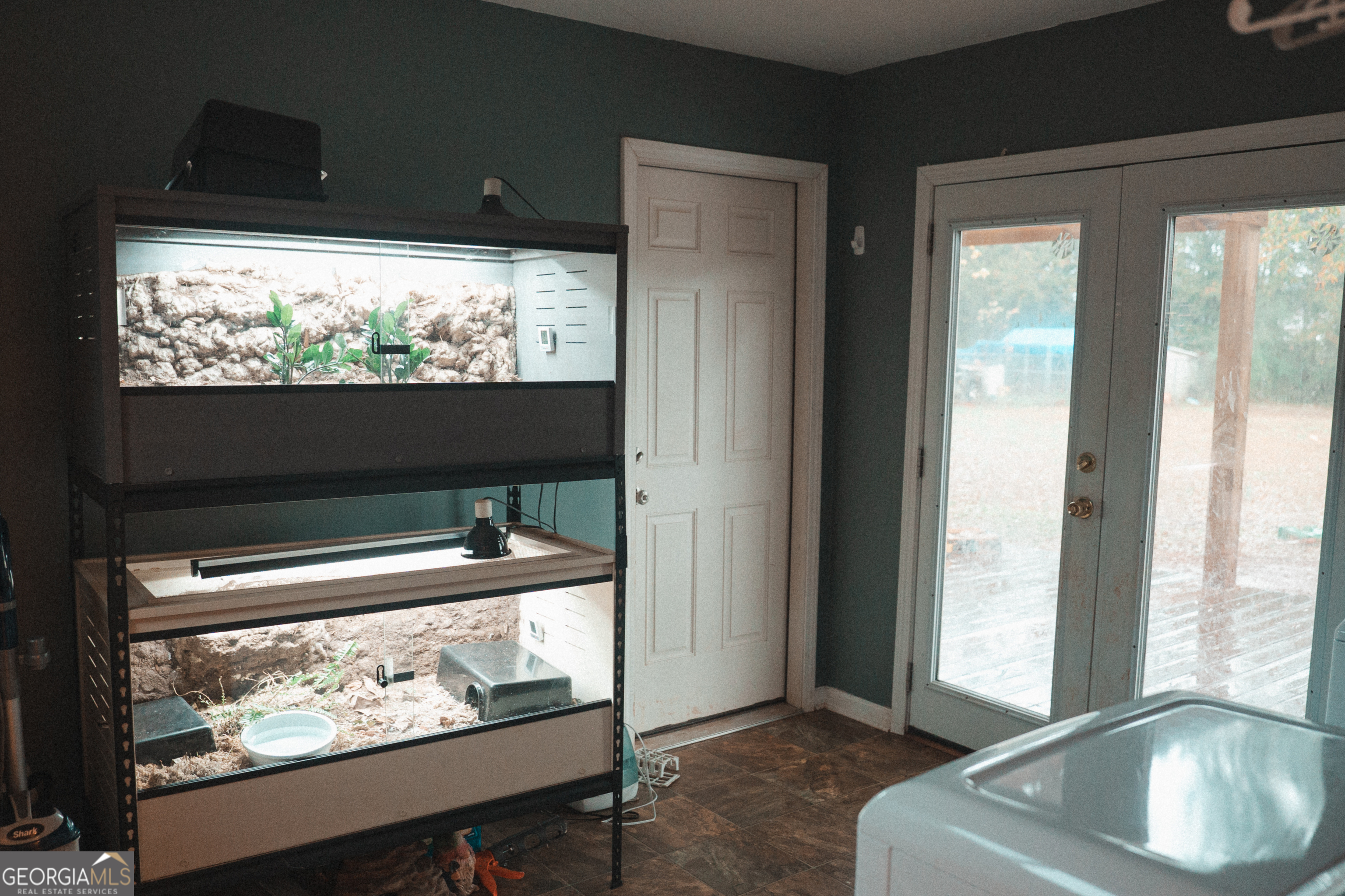 1145 Larkspur Drive Locust Grove, GA 30248 - Photo 11 of 15 a living room with large window and a flat screen tv