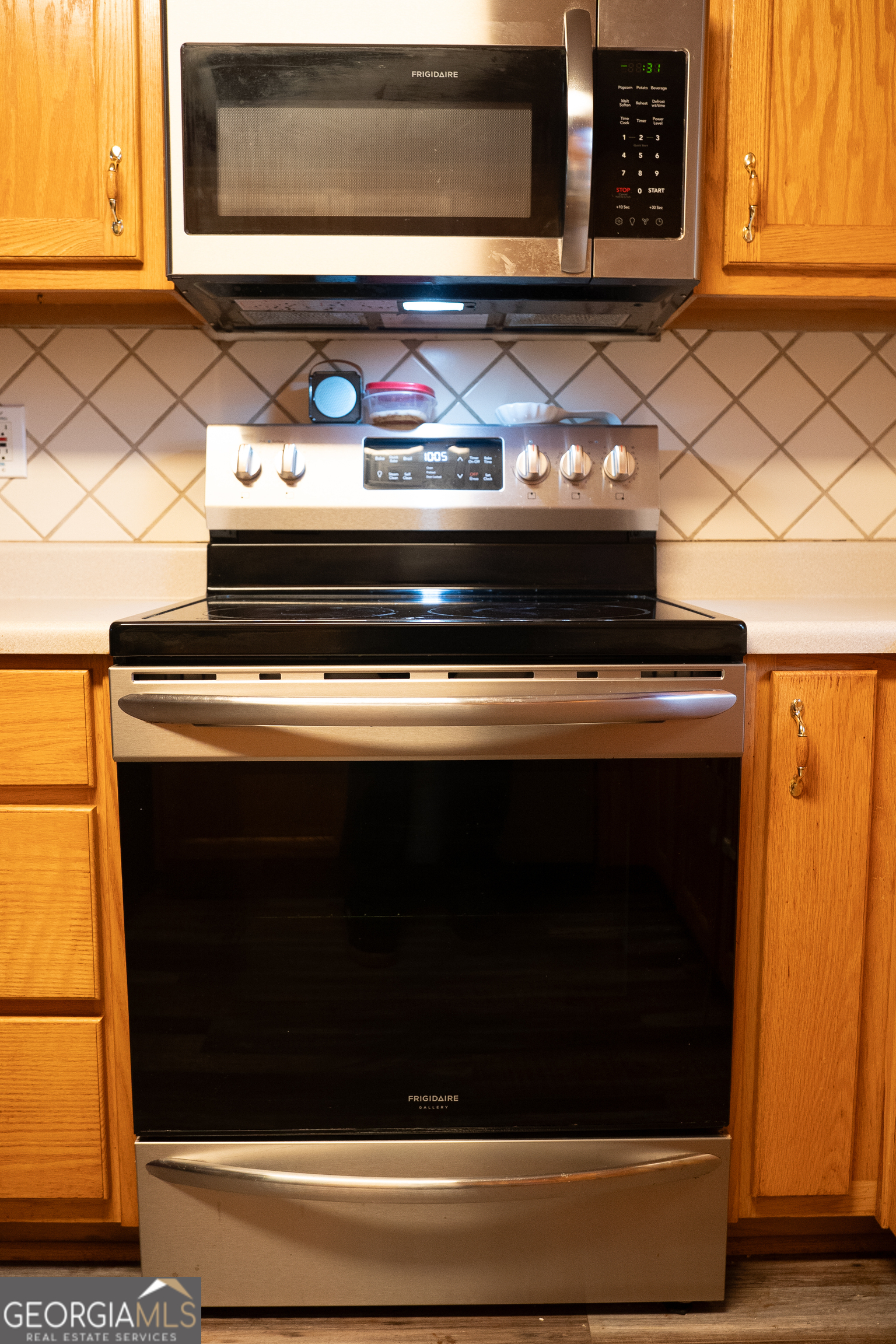1145 Larkspur Drive Locust Grove, GA 30248 - Photo 15 of 15 a stove top oven sitting inside of a kitchen