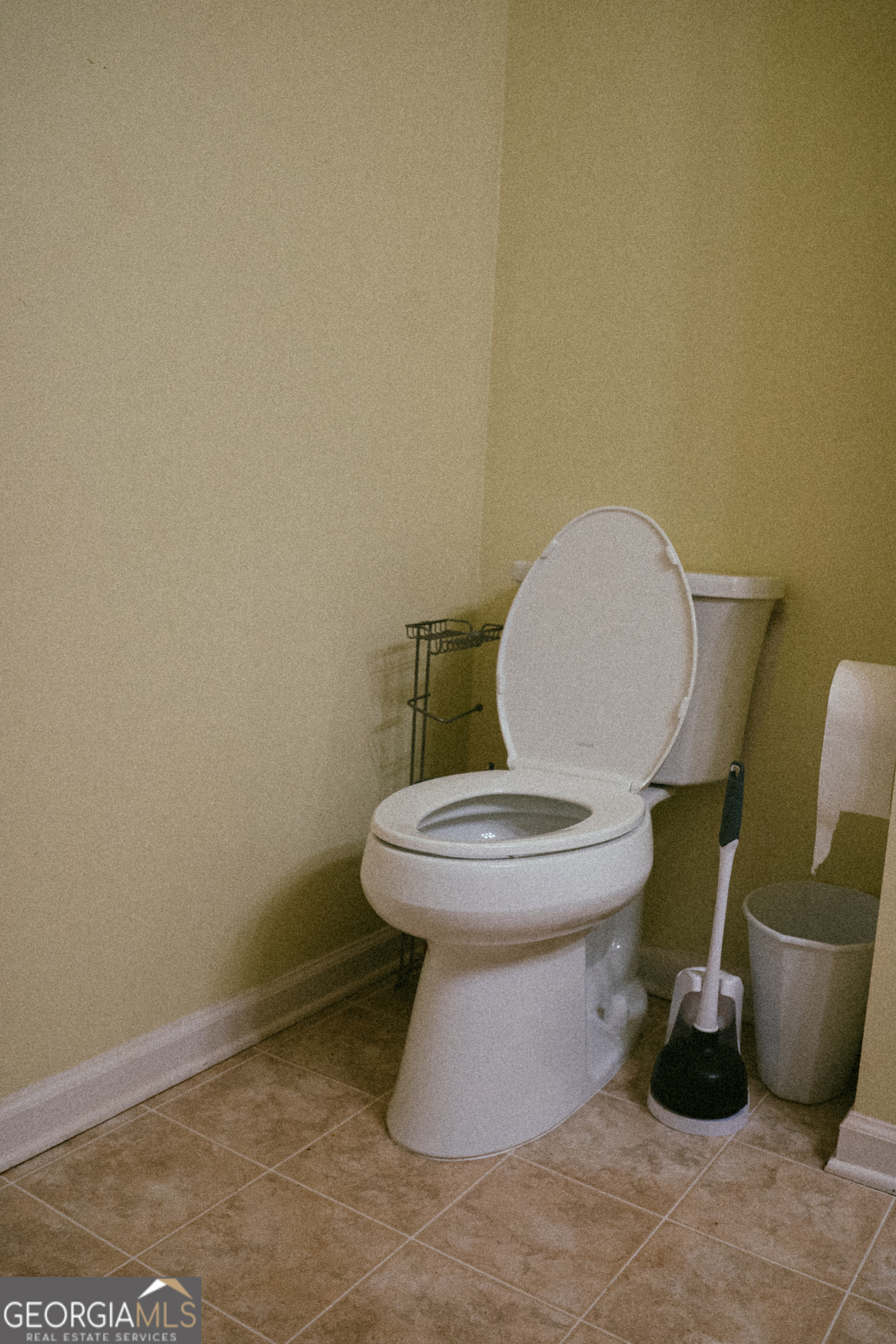 1145 Larkspur Drive Locust Grove, GA 30248 - Photo 5 of 15 a white toilet sitting next to a sink