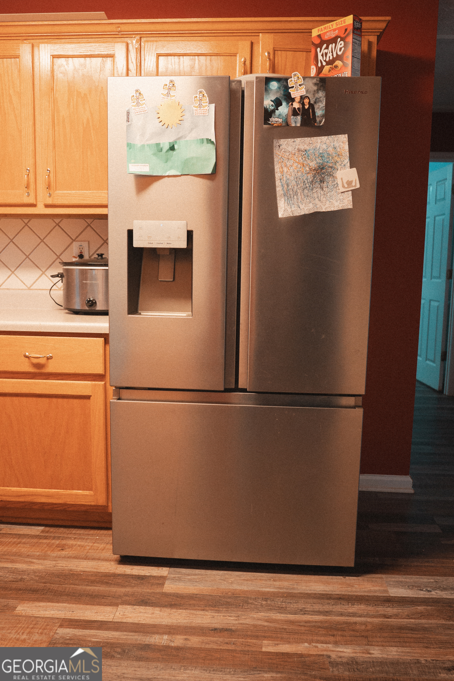 1145 Larkspur Drive Locust Grove, GA 30248 - Photo 10 of 15 a white refrigerator freezer sitting on top of a wooden floor