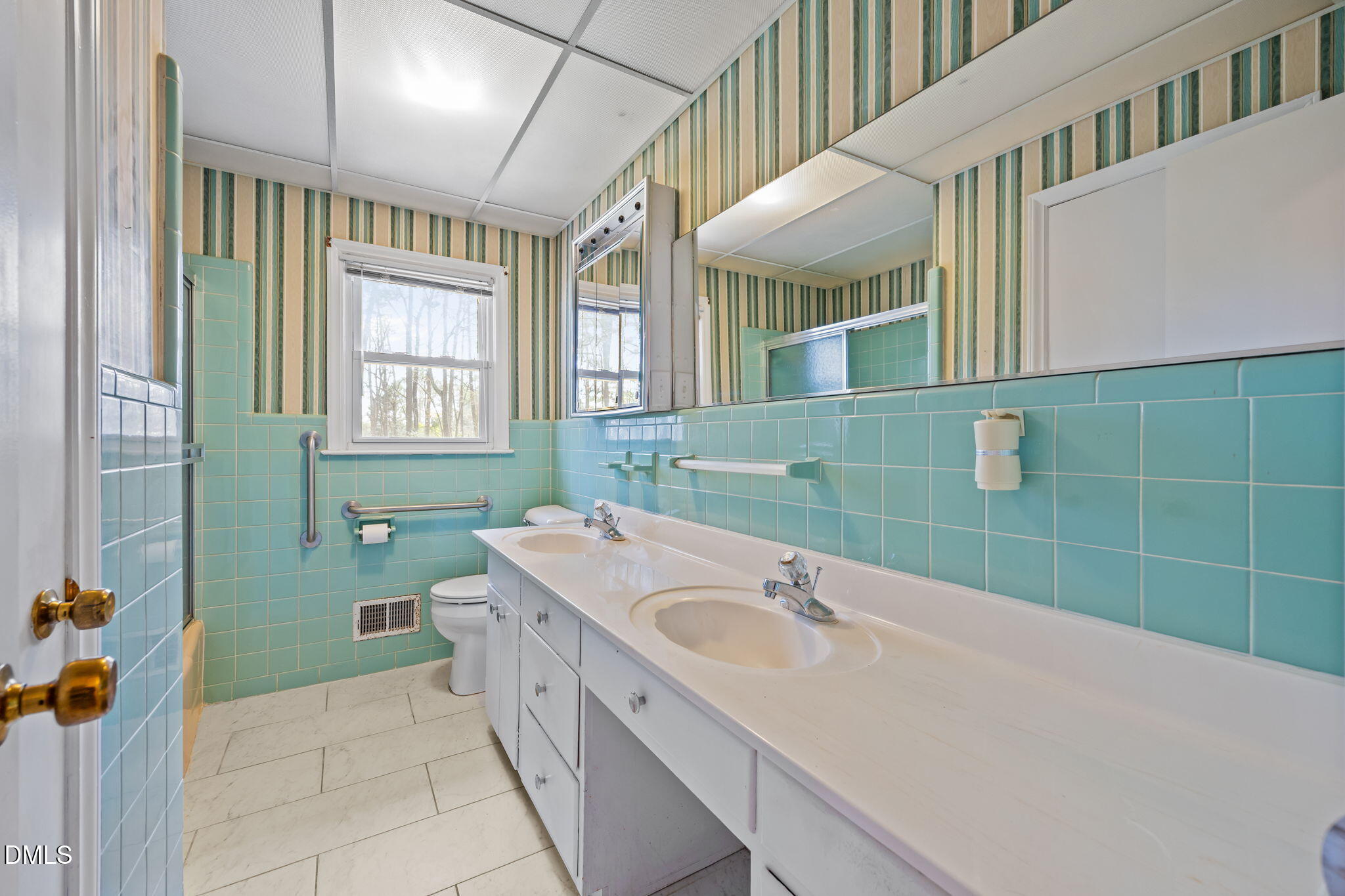 2009 Philcrest Road Raleigh, NC 27612 - Photo 12 of 29 a bathroom with a sink a toilet and a mirror
