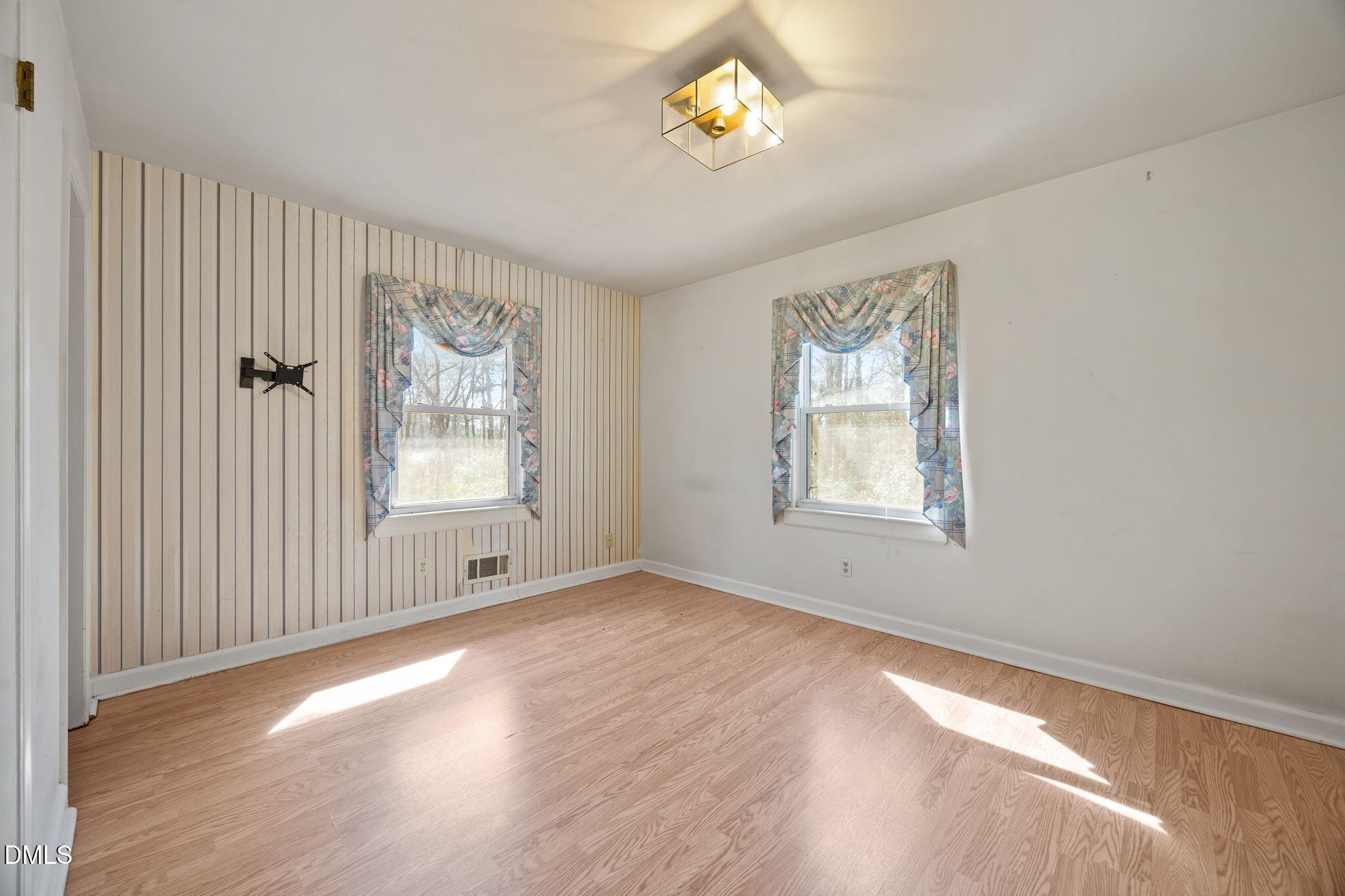 2009 Philcrest Road Raleigh, NC 27612 - Photo 15 of 29 a view of an empty room with a window and wooden floor