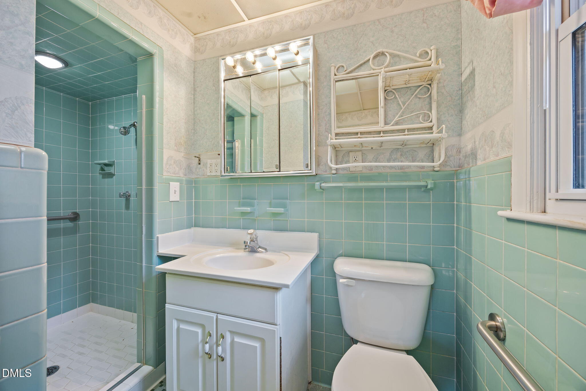 2009 Philcrest Road Raleigh, NC 27612 - Photo 16 of 29 a bathroom with a toilet sink and mirror