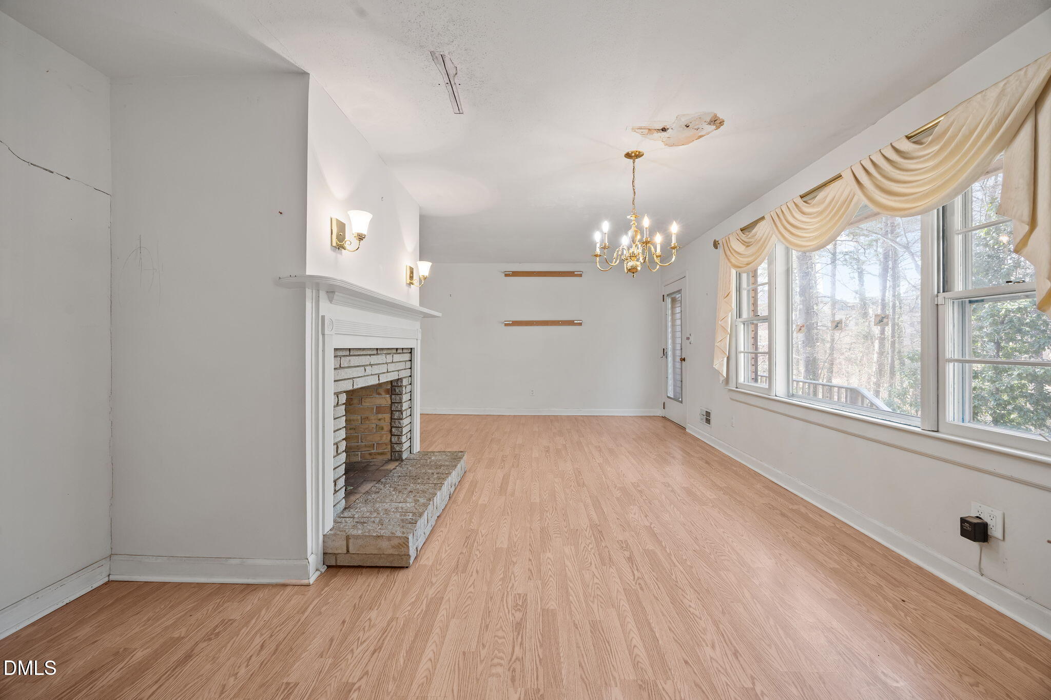 2009 Philcrest Road Raleigh, NC 27612 - Photo 19 of 29 a view of an empty room with a window and wooden floor
