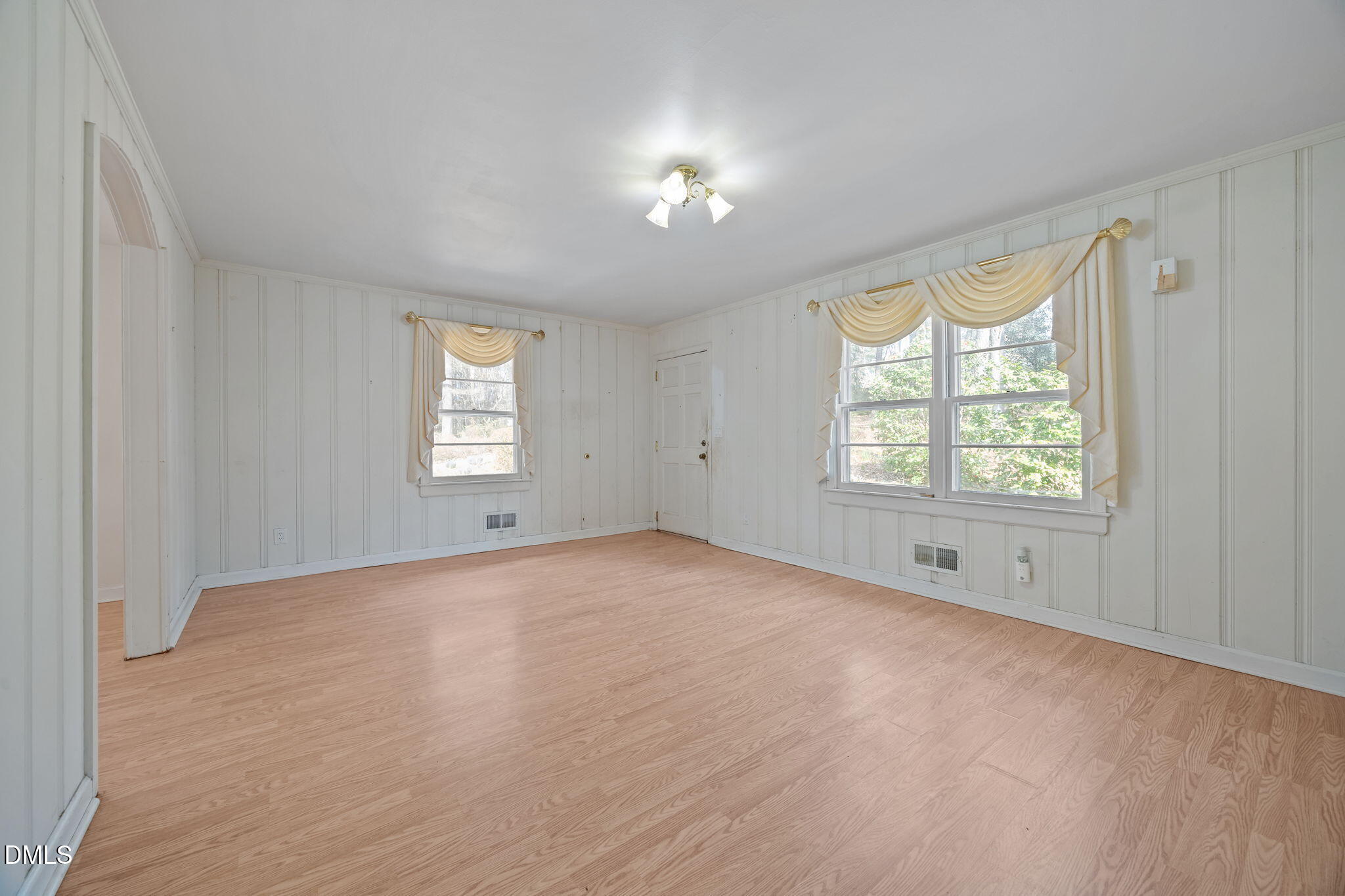 2009 Philcrest Road Raleigh, NC 27612 - Photo 5 of 29 a view of an empty room with a window and wooden floor