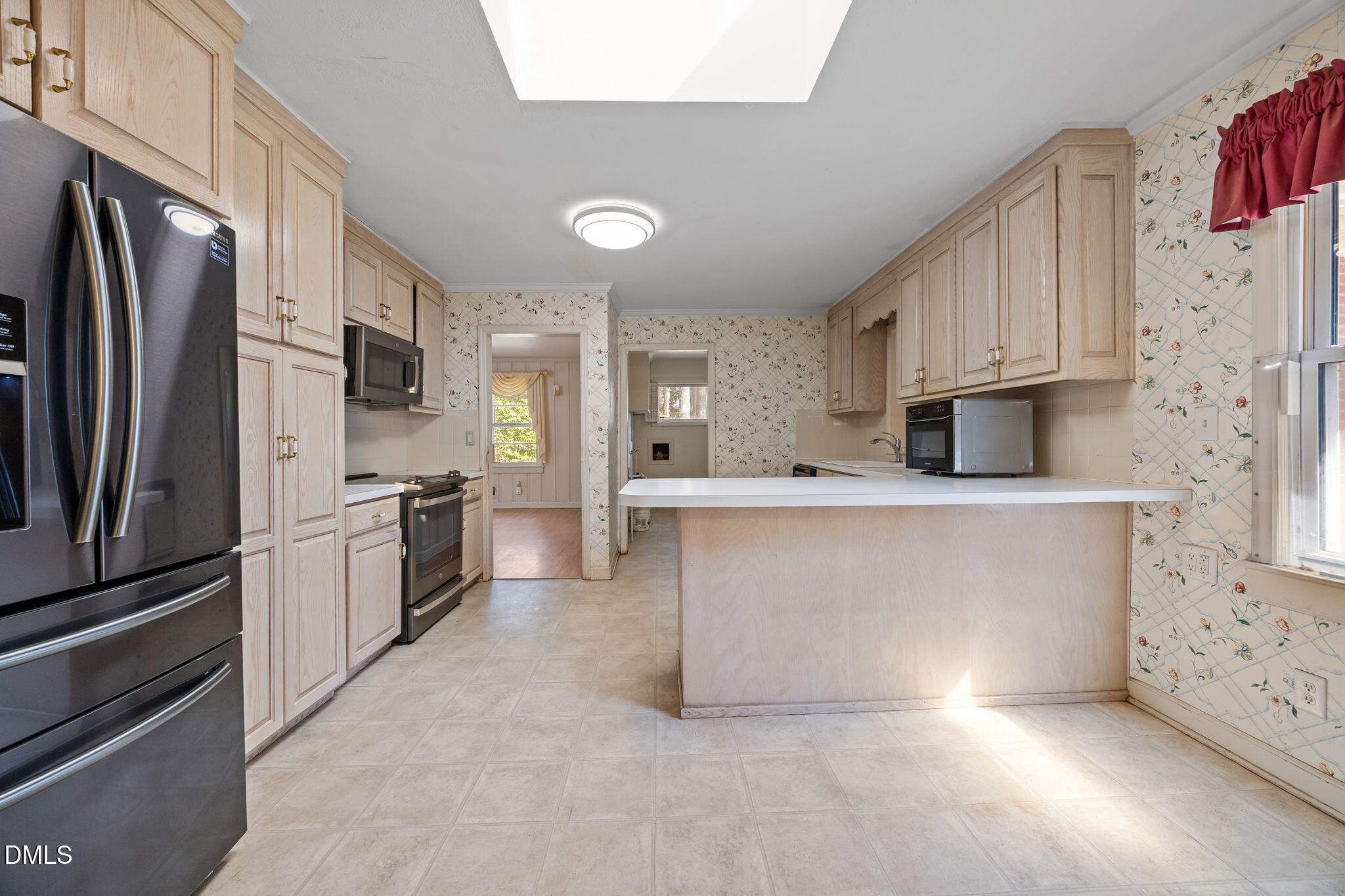 2009 Philcrest Road Raleigh, NC 27612 - Photo 8 of 29 a kitchen with stainless steel appliances white cabinets and wooden floors