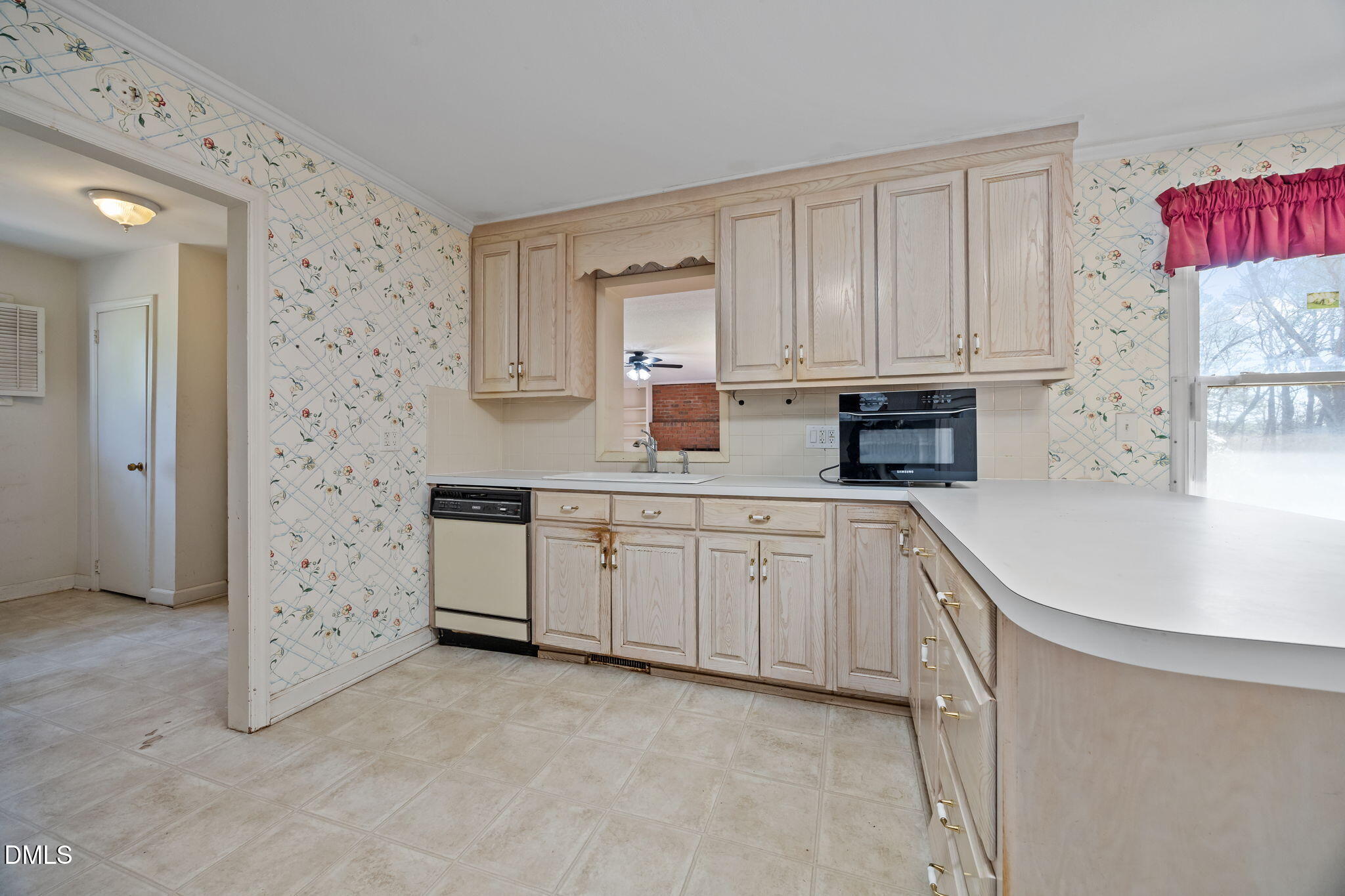 2009 Philcrest Road Raleigh, NC 27612 - Photo 9 of 29 a kitchen with granite countertop a sink a stove and cabinets
