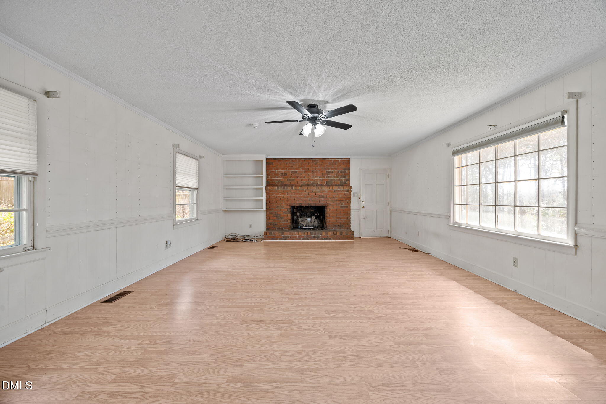2009 Philcrest Road Raleigh, NC 27612 - Photo 10 of 29 an empty room with windows and fireplace