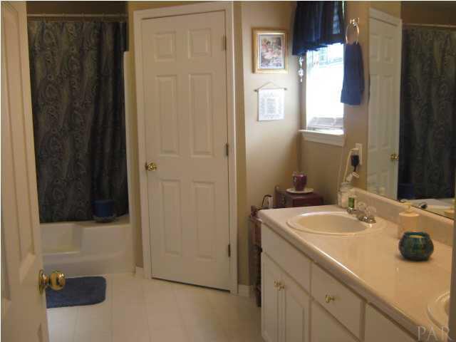 7165 Woodside Road Pensacola, FL 32526 - Photo 14 of 23 Master bathroom with walk in closet and garden tub.