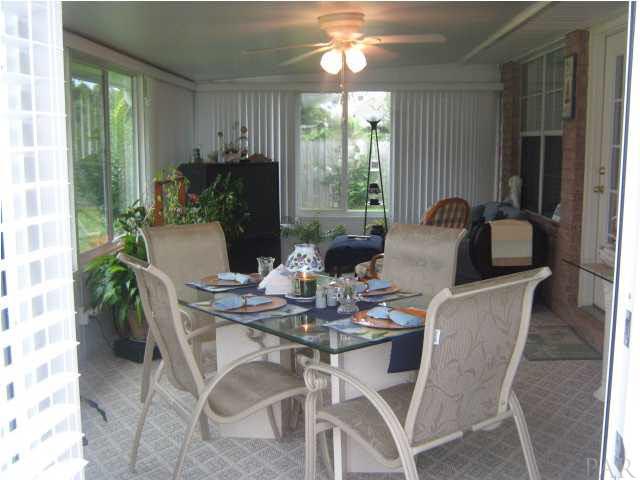 7165 Woodside Road Pensacola, FL 32526 - Photo 4 of 23 Florida Room with many sliding windows and heat pump that keeps the climate just right.