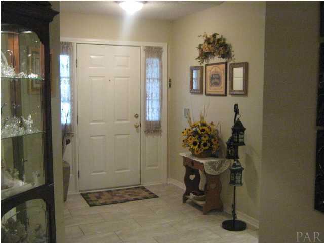 7165 Woodside Road Pensacola, FL 32526 - Photo 5 of 23 Greet your visitors in this elegant foyer with tiled floors.