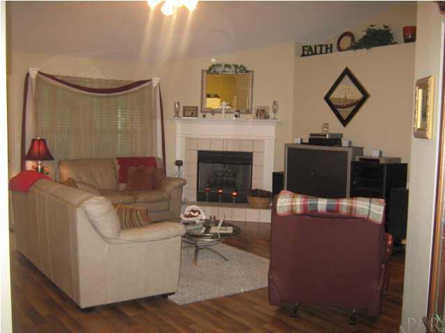 7165 Woodside Road Pensacola, FL 32526 - Photo 6 of 23 The great room is cozy and inviting, has wood floors and gas fireplace.