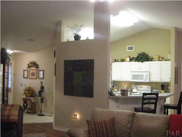 7165 Woodside Road Pensacola, FL 32526 - Photo 7 of 23 View from living room towards kitchen and foyer. Notice the high ceilings throughout all the living areas.