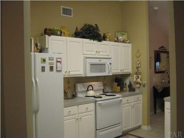 7165 Woodside Road Pensacola, FL 32526 - Photo 9 of 23 Kitchen with warm wall colors and plenty of cabinetry and counter space.