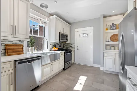 a kitchen with cabinets and window