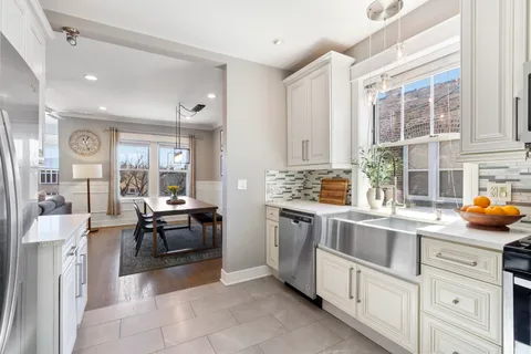 a kitchen with sink cabinets and stove top oven