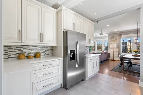 a kitchen with stainless steel appliances a refrigerator sink and cabinets