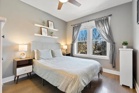 a bedroom with a bed and a chandelier