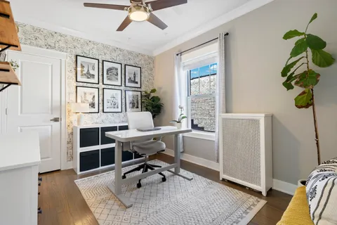 a workspace with wooden floor and a window