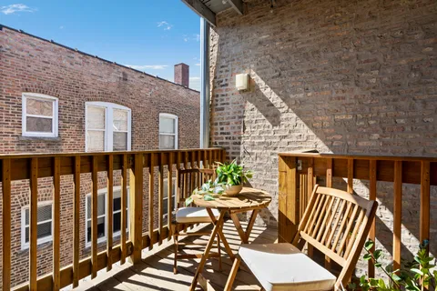 a view of a chairs and table in the balcony