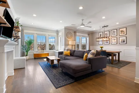 a living room with furniture a couch and a flat screen tv