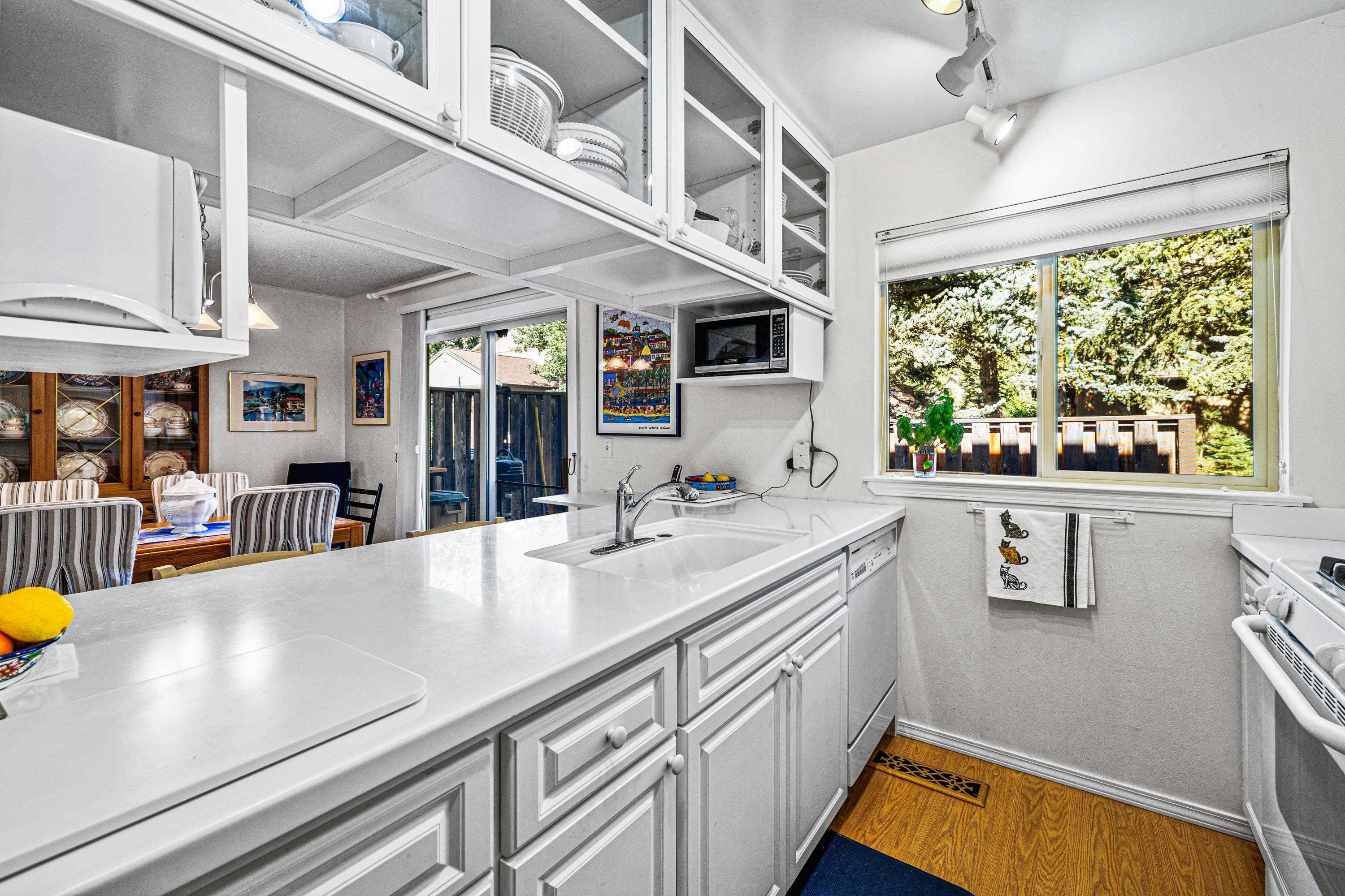 3101 Lake Forest Road, Unit 163 Tahoe City, CA 96145 - Photo 12 of 21 a view of a kitchen with stainless steel appliances granite countertop a sink and a large window