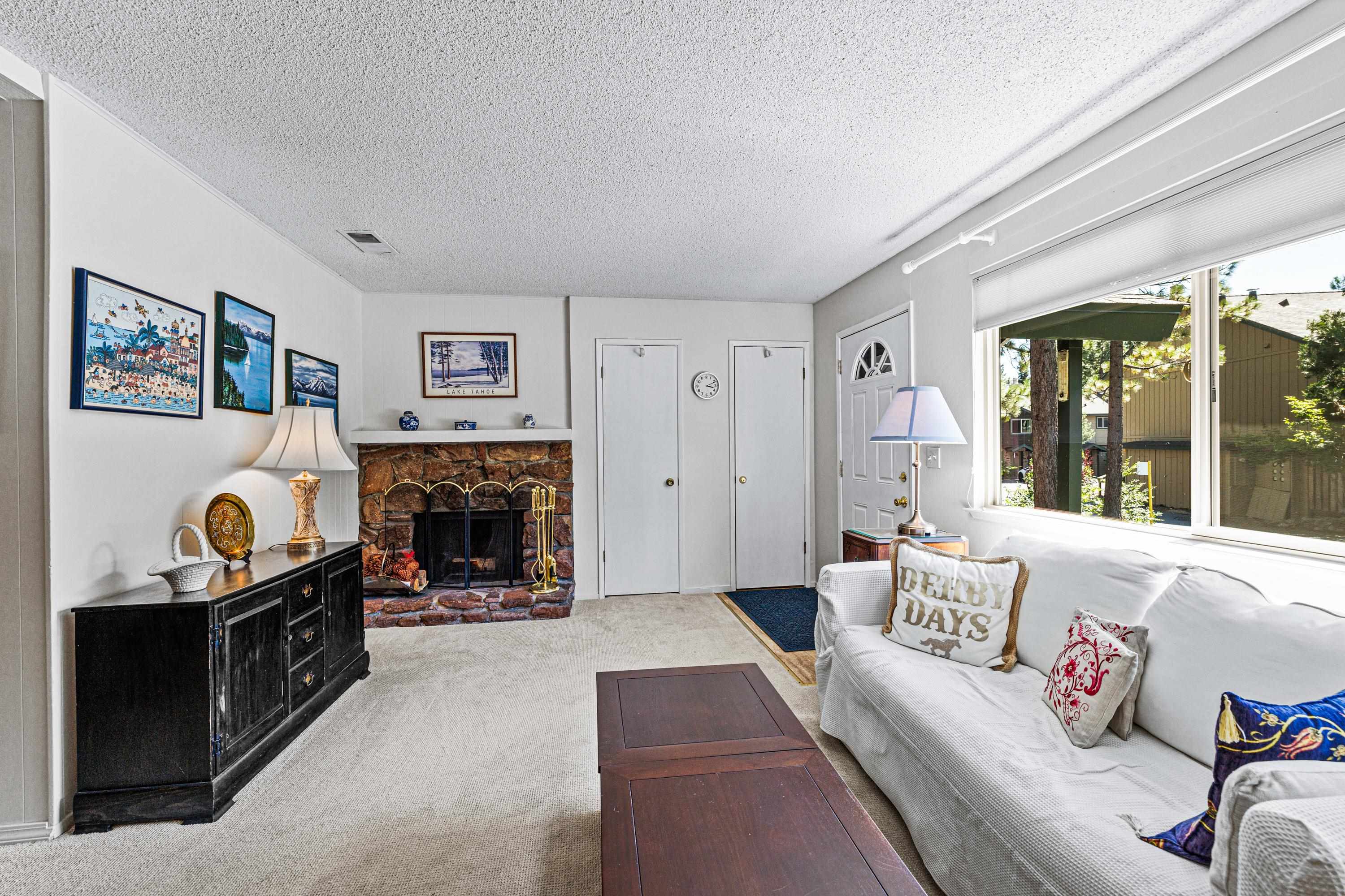 3101 Lake Forest Road, Unit 163 Tahoe City, CA 96145 - Photo 4 of 21 a living room with furniture and a fireplace