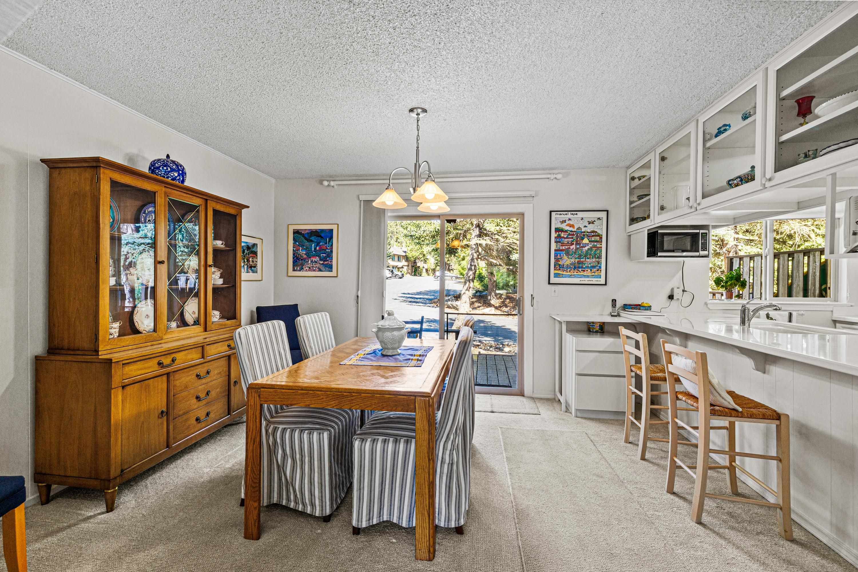 3101 Lake Forest Road, Unit 163 Tahoe City, CA 96145 - Photo 6 of 21 a dining room with furniture a chandelier and window
