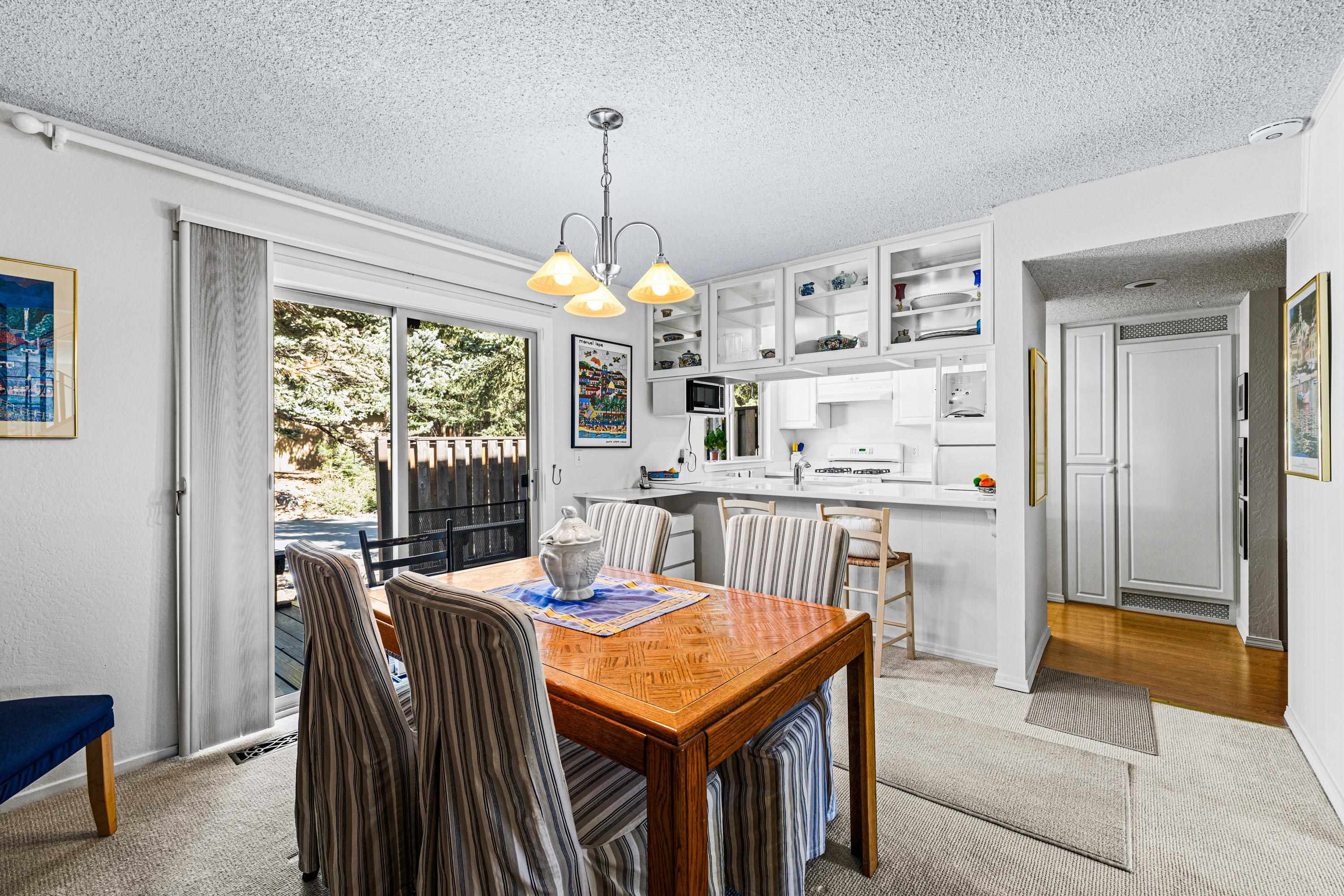 3101 Lake Forest Road, Unit 163 Tahoe City, CA 96145 - Photo 7 of 21 a dining room with furniture a chandelier and window