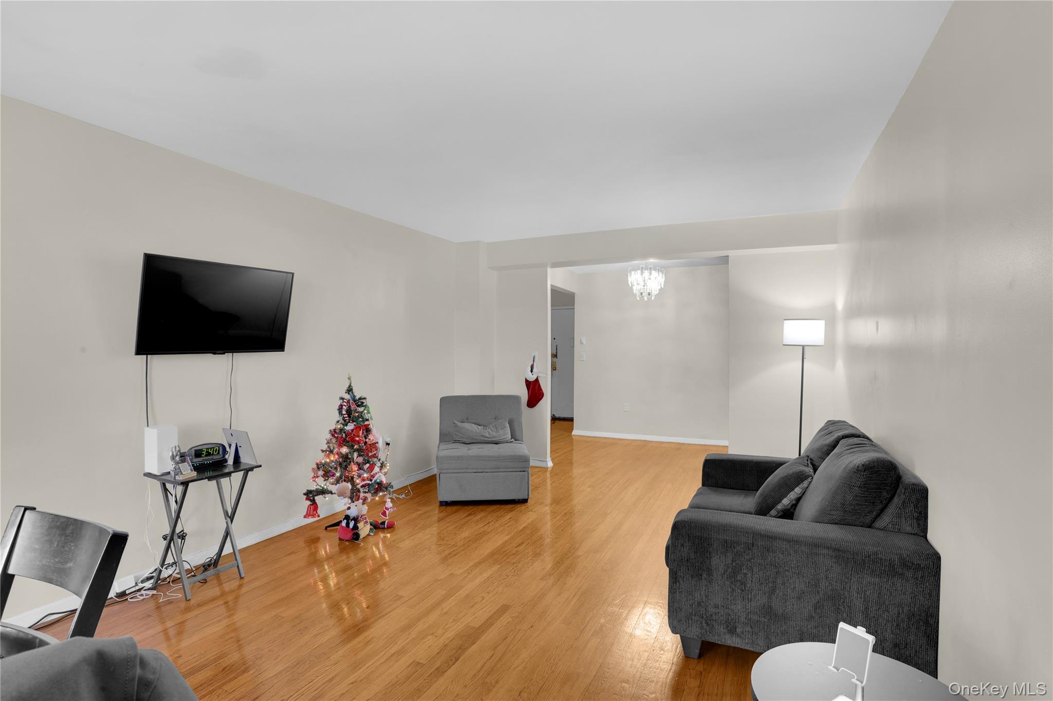 245 Bronx River Road, Unit 7C Yonkers, NY 10704 - Photo 11 of 23 a living room with furniture and a flat screen tv