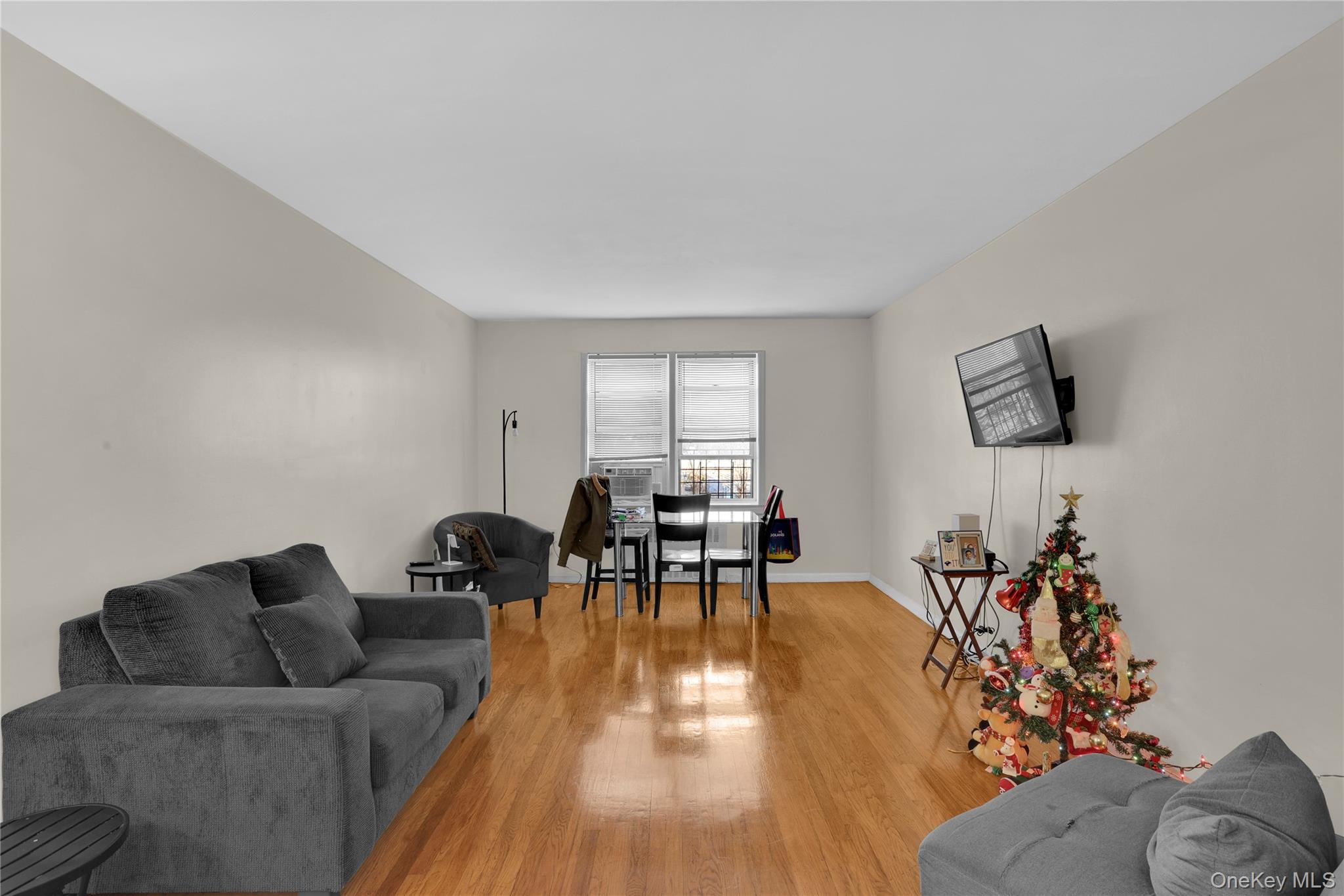 245 Bronx River Road, Unit 7C Yonkers, NY 10704 - Photo 14 of 23 a living room with furniture and wooden floor