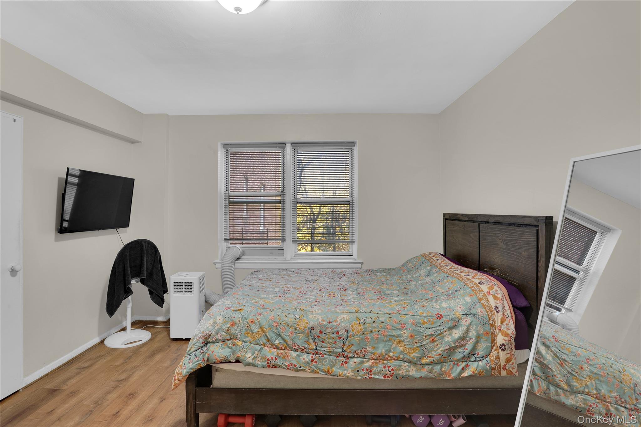 245 Bronx River Road, Unit 7C Yonkers, NY 10704 - Photo 17 of 23 a bedroom with a bed and a flat screen tv