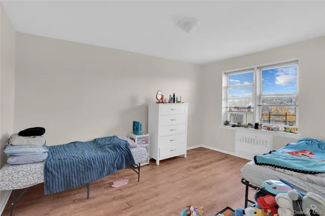 a bedroom with furniture and a window