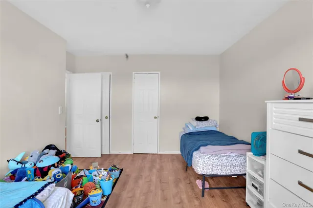 a bedroom with a bed and a dresser in it