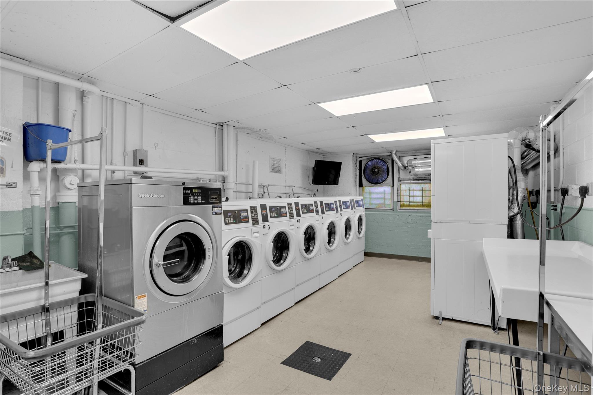 245 Bronx River Road, Unit 7C Yonkers, NY 10704 - Photo 21 of 23 a kitchen with stainless steel appliances a white cabinet and a sink
