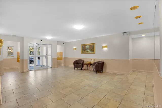 a lobby with furniture and two chairs