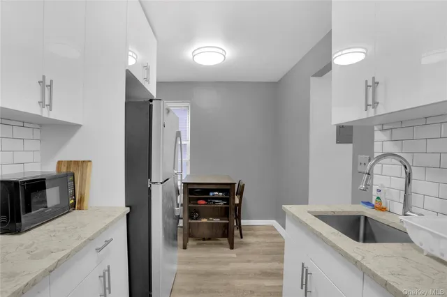 a kitchen with a sink cabinets and stainless steel appliances