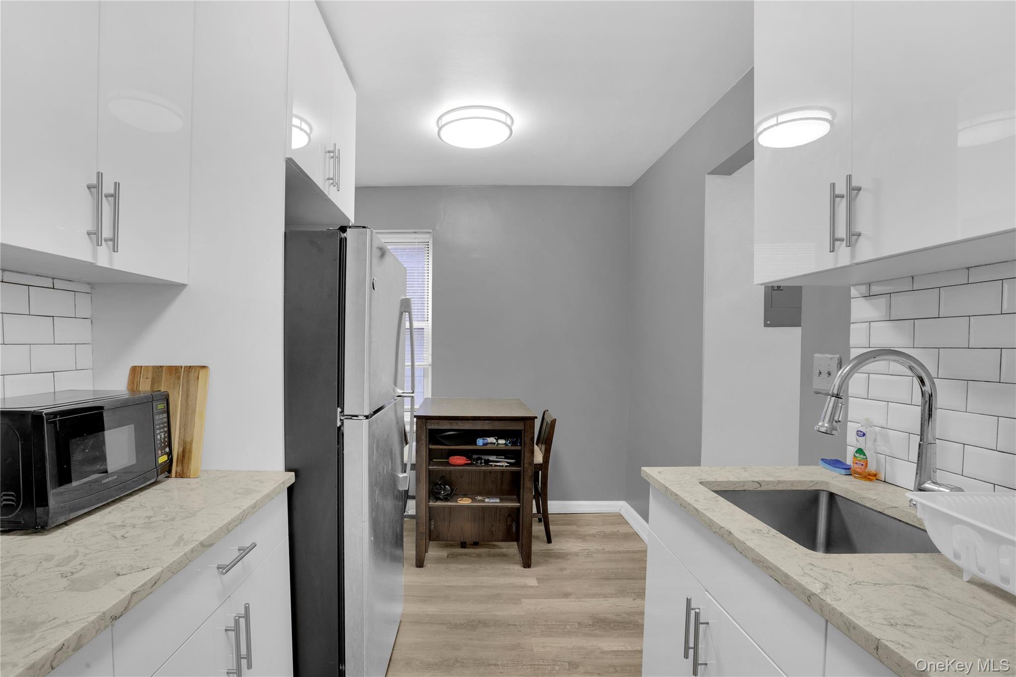 245 Bronx River Road, Unit 7C Yonkers, NY 10704 - Photo 7 of 23 a kitchen with a sink cabinets and stainless steel appliances