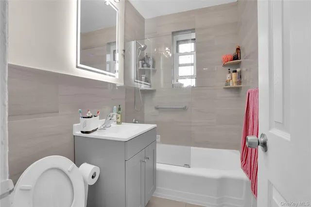 a bathroom with a sink mirror and a bathtub