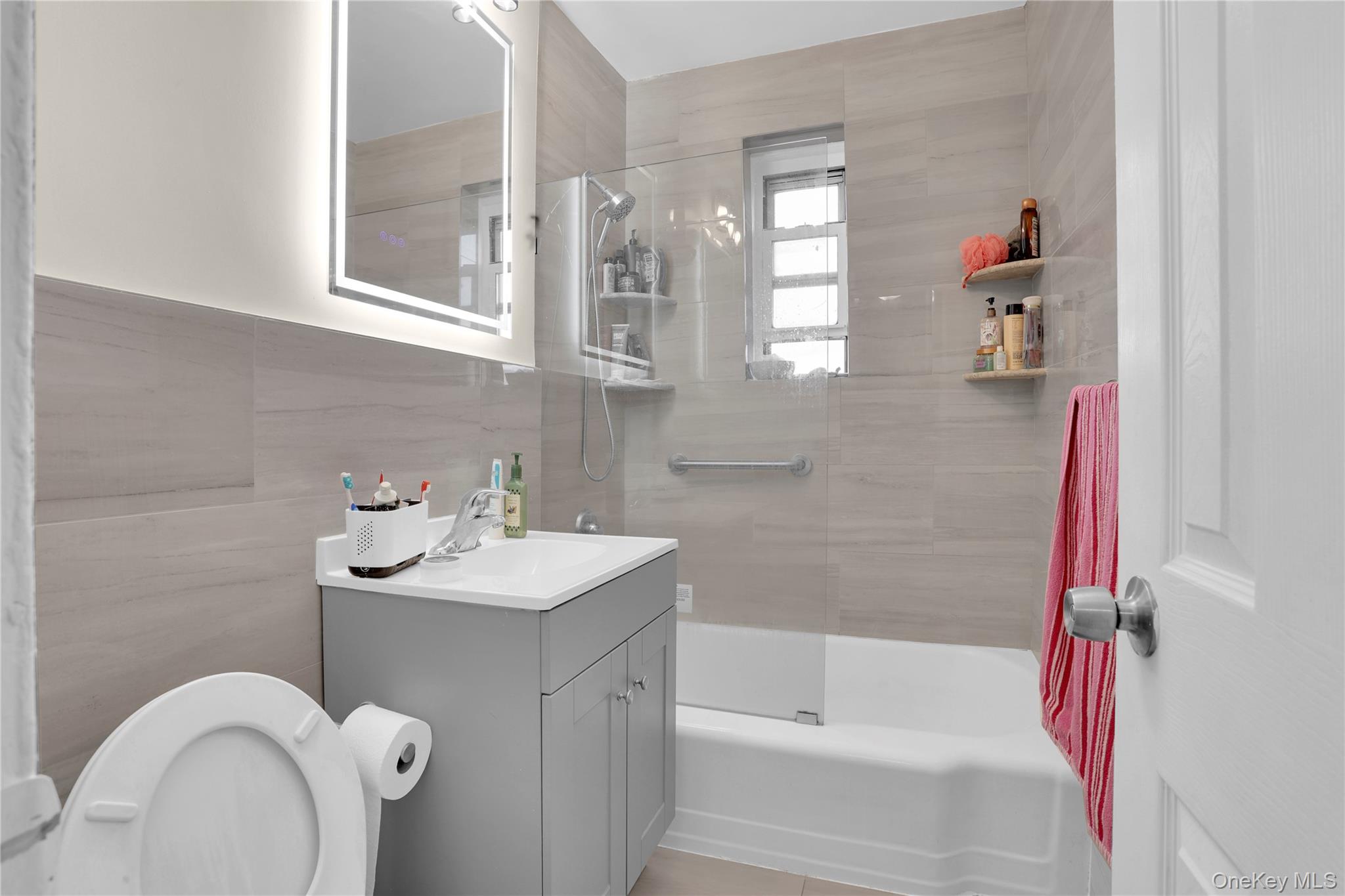 245 Bronx River Road, Unit 7C Yonkers, NY 10704 - Photo 9 of 23 a bathroom with a sink mirror and a bathtub