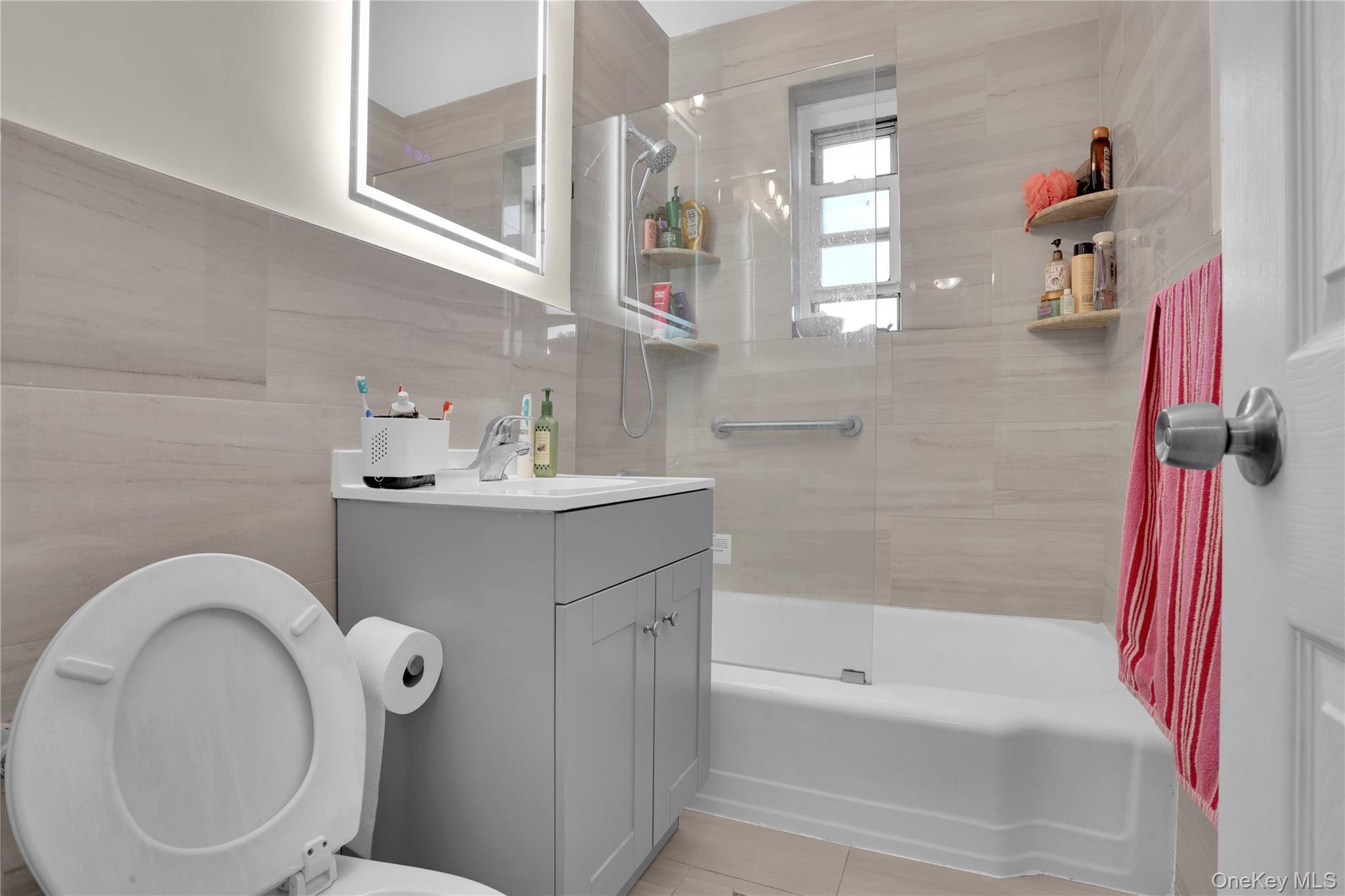 245 Bronx River Road, Unit 7C Yonkers, NY 10704 - Photo 10 of 23 a bathroom with a sink a toilet and shower