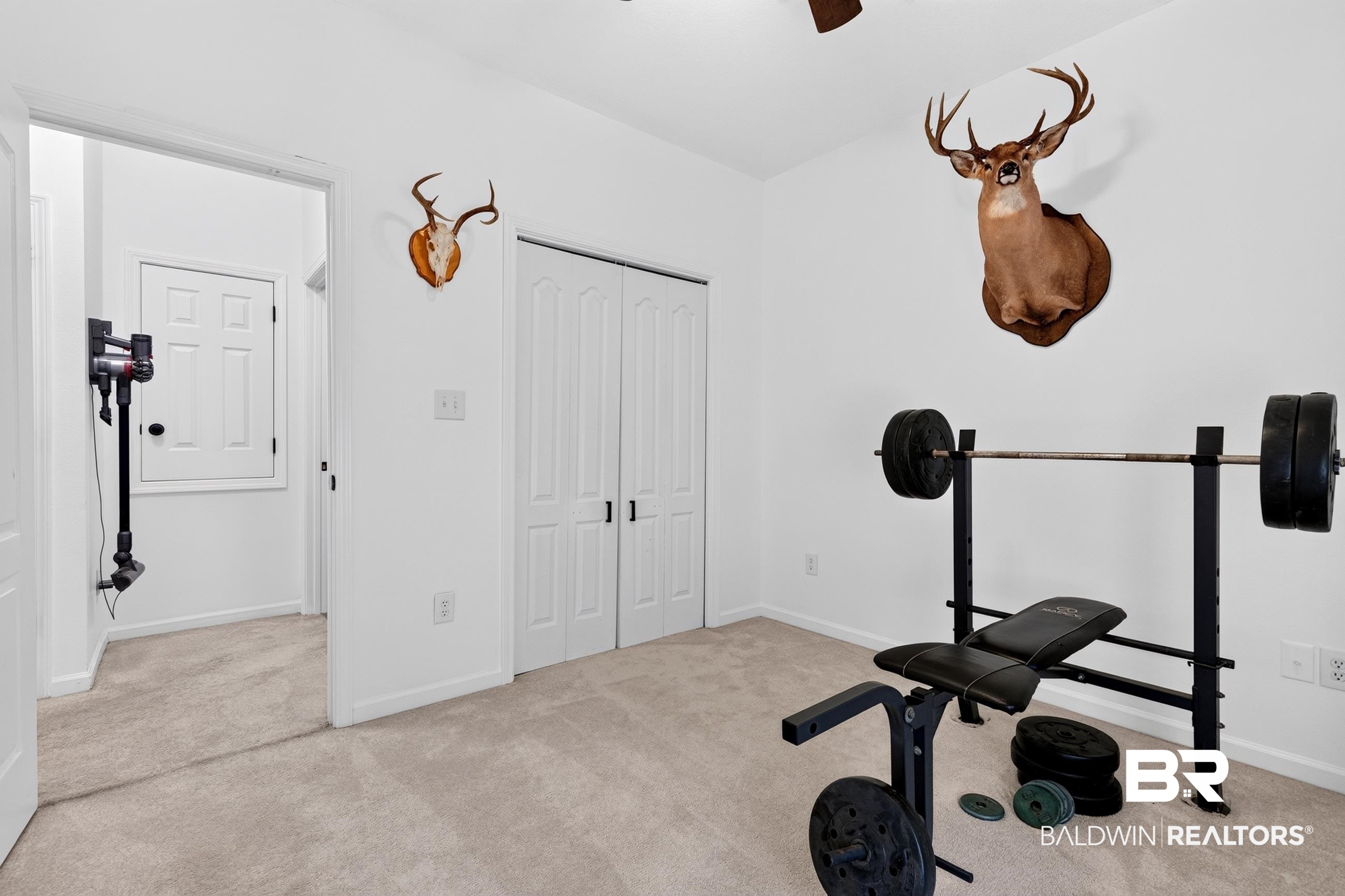 17419 Lewis Smith Drive Foley, AL 36535 - Photo 29 of 38 Carpeted room with white walls, featuring a ceiling fan and a double bi-fold closet