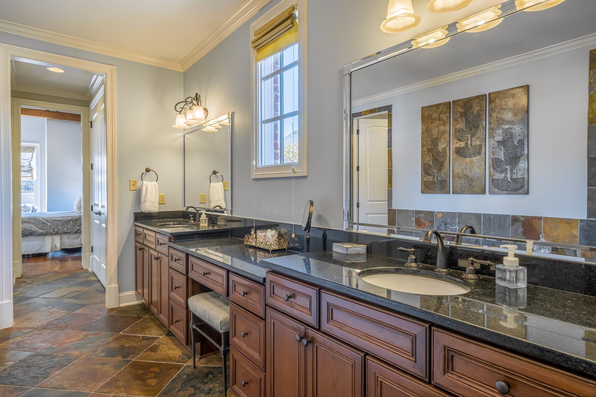 1247 Braywind Drive Collierville, TN 38017 - Photo 12 of 25 a bathroom with a granite countertop sink a mirror and a shower
