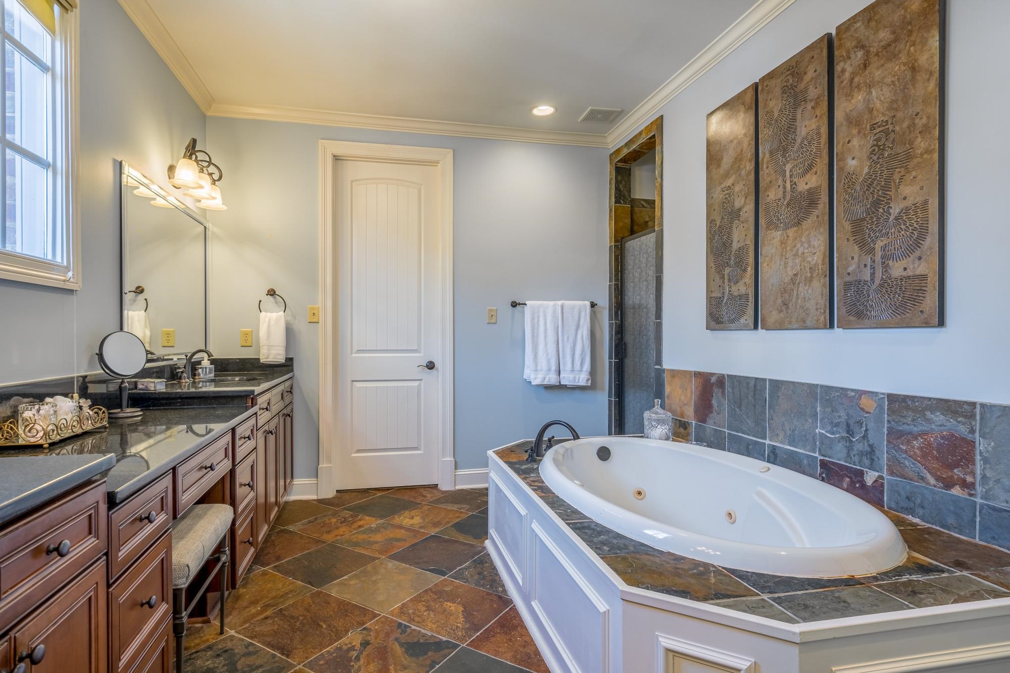 1247 Braywind Drive Collierville, TN 38017 - Photo 13 of 25 a bathroom with a granite countertop tub a double vanity sink a vanity and a window